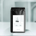 StepUp coffee bag with whole bean label, sleek black packaging, and minimalist design